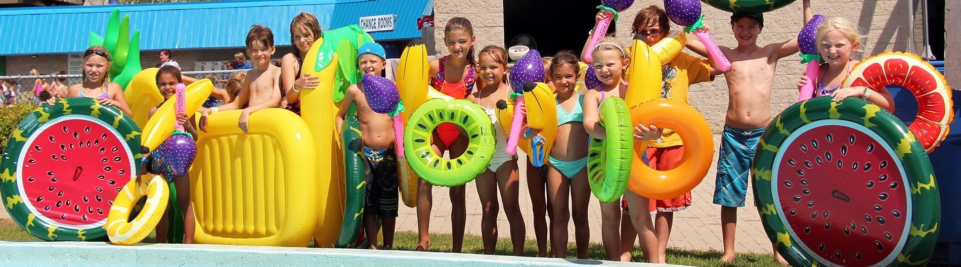 A group of kids standing beside a pool at earl haig family fun park.