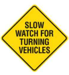 Slow Watch for Turning Vehicles Sign