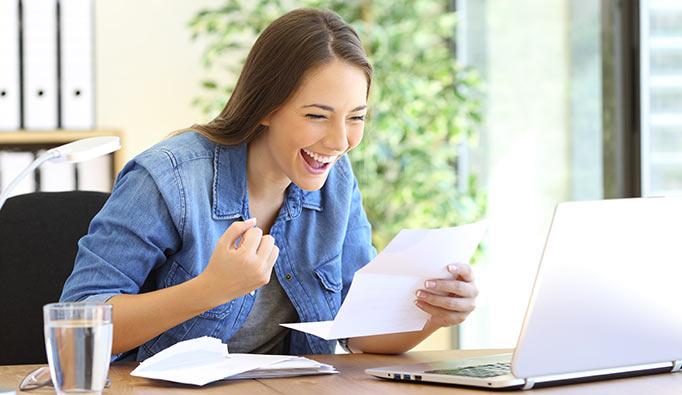 Woman happy at a computer