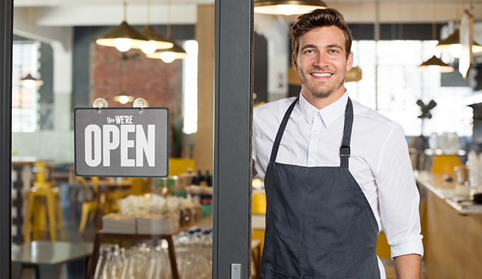 Man with business with open sign