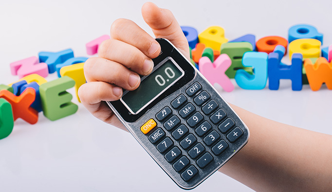 child holding calculator