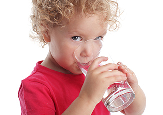 young boy drinking water