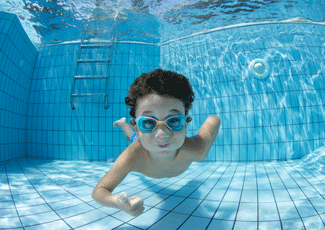 A kid underwater with goggles on