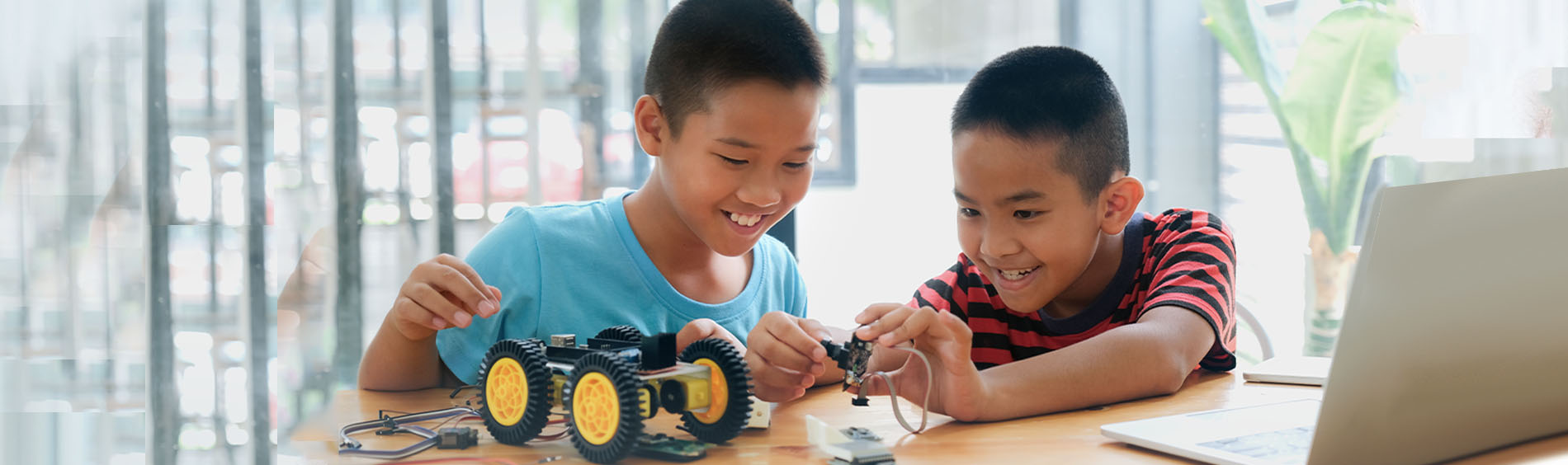 Boys doing a STEAM activity at a desk