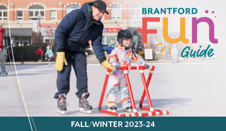 The cover of the Brantford FUN Guide featuring dad and daughter skating on the ice rink