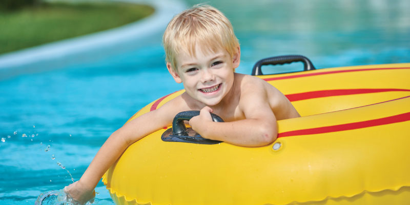 Child in lazy river in innertube