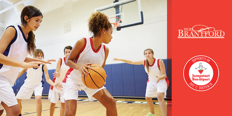 A group of teen girls play basketball