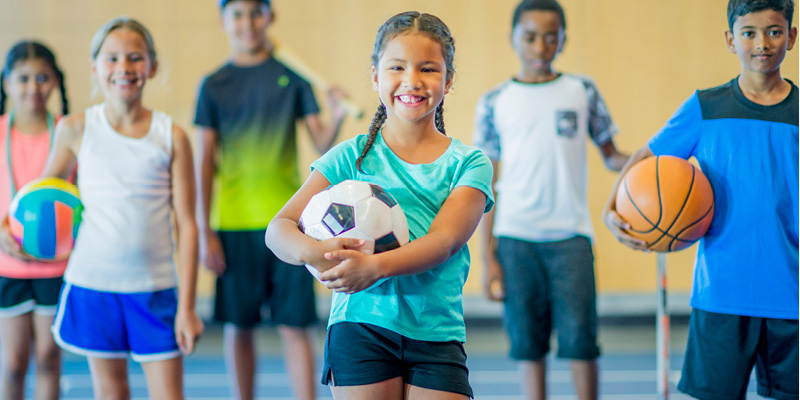 Kids playing sports in a gym