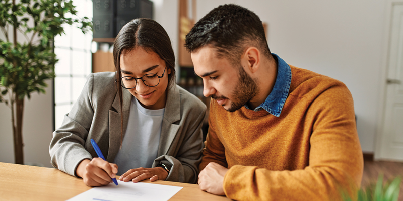 two people looking at paperwork