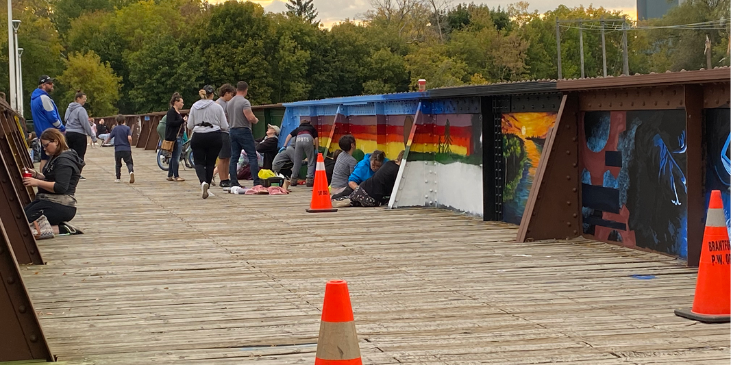 Community members on the TH&B bridge painting the interior panels