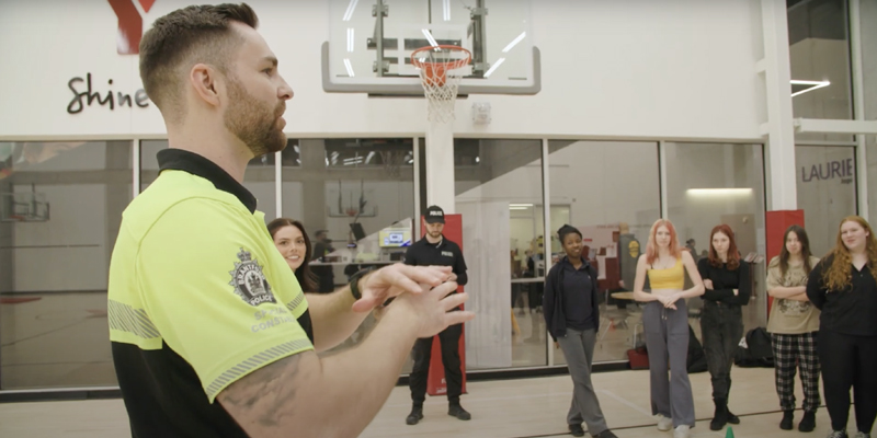 A Brantford Police officer talks to a YES program participants