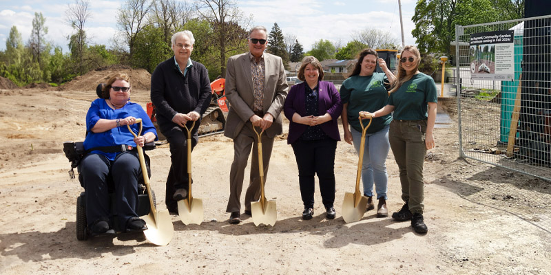 Photo of group with gold shovels breaking ground at Woodman Park