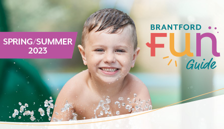 The cover of the Brantford FUN Guide featuring a young boy playing in a splash pad