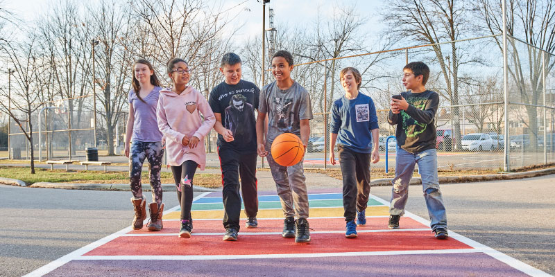 Youth walking across rainbow walk