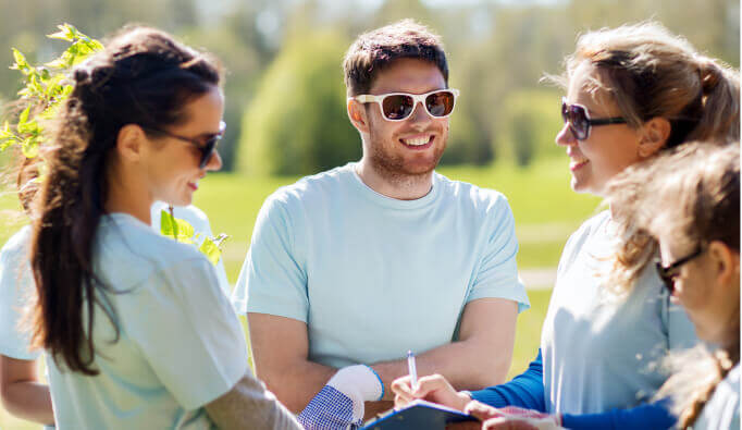 Group of people wearing sunglasses and smiling