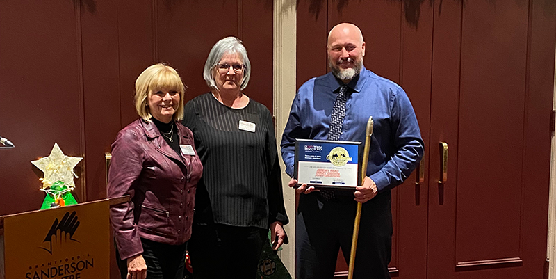 DBBIA Chair Barbara Sutherland and Executive Director Annette Wawzonek presenting the Golden Broom Award to City of Brantford Operational Services staff member Jeremy Read