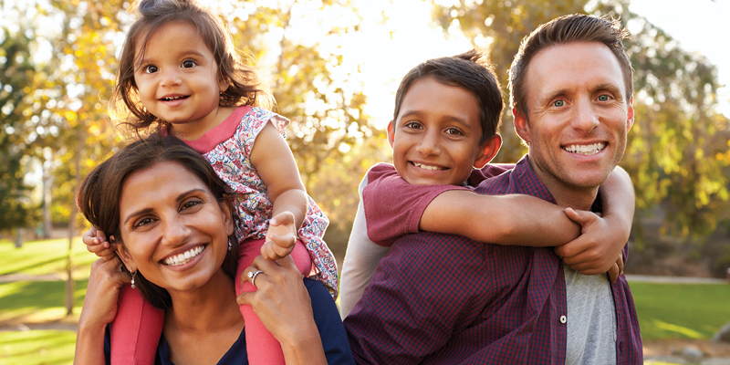 A family standing together in a park