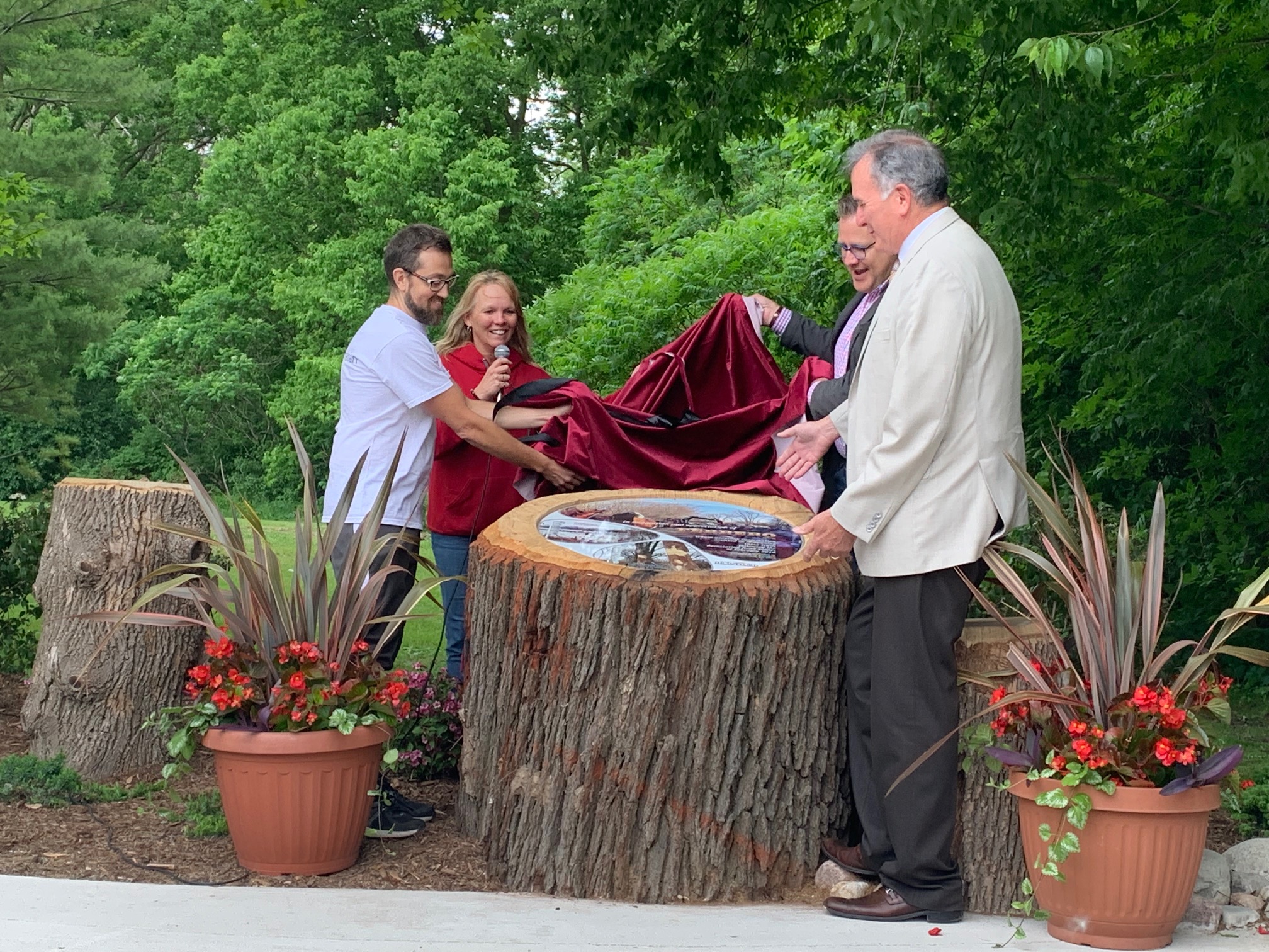 Ferrero and City staff unveiling the plaque