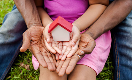 picture of hands holding a toy house