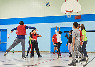 teens playing basketball