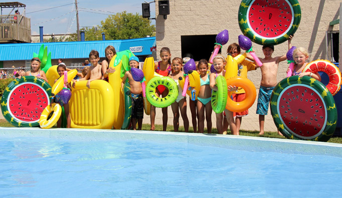 A group of kids standing beside a pool at Earl Haig