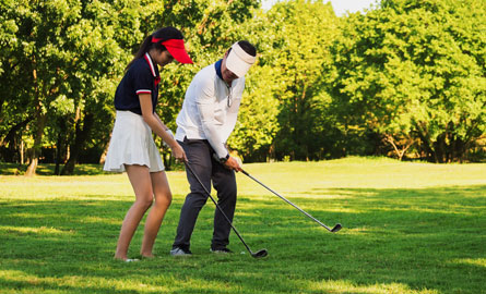 golf instructor with student