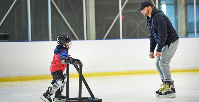 Father and son skating on ice