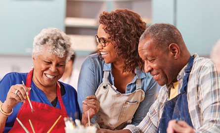 Three older adults at an art class