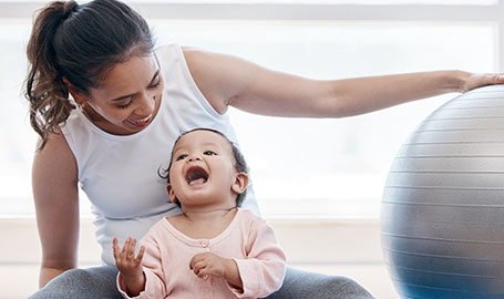 Parent and child smiling and looking at one another