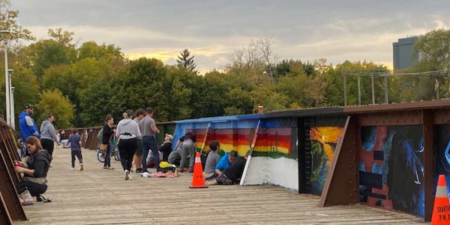 Community members painting panels of the TH&B crossing