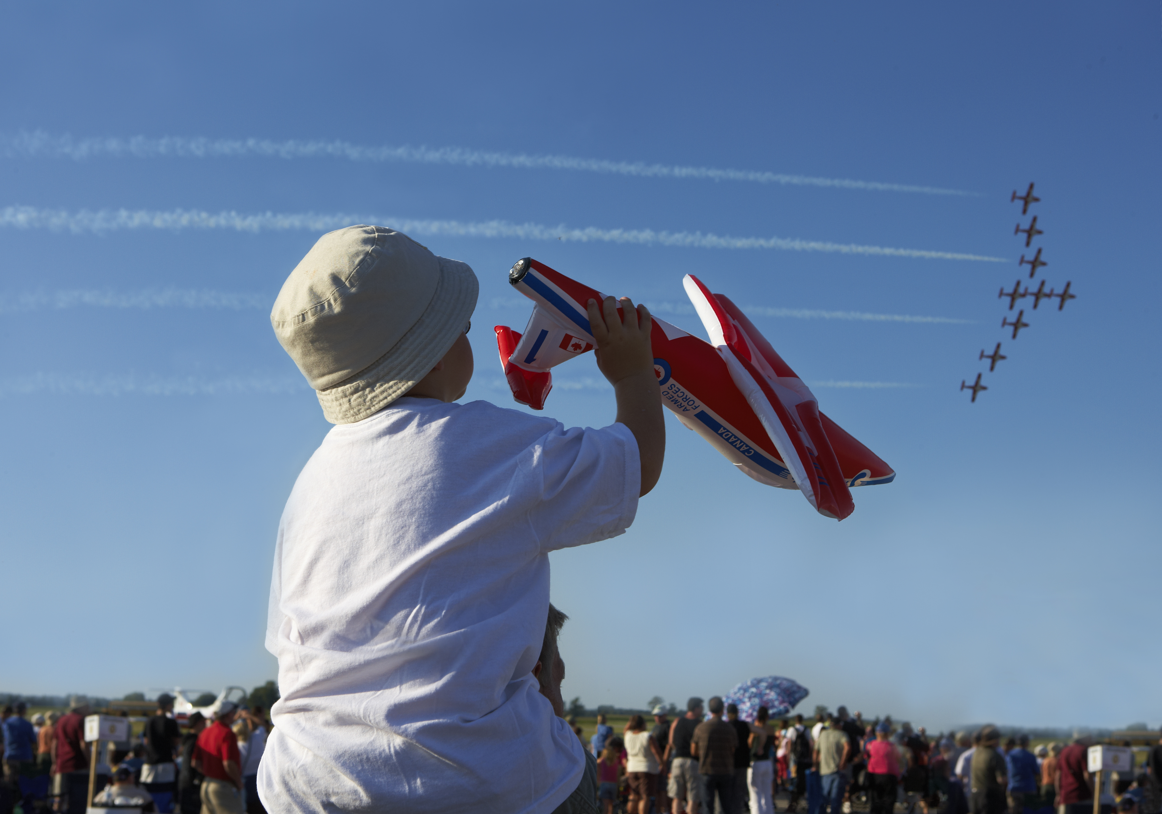 Small child watching planes airshow