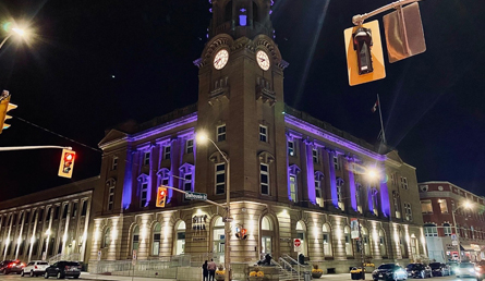 City Hall illuminated with purple lighting in honour of those impacted by Intimate Partner Violence