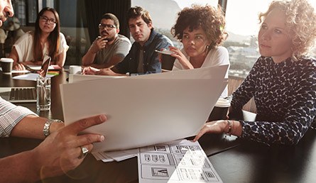 group of employees discussing plans