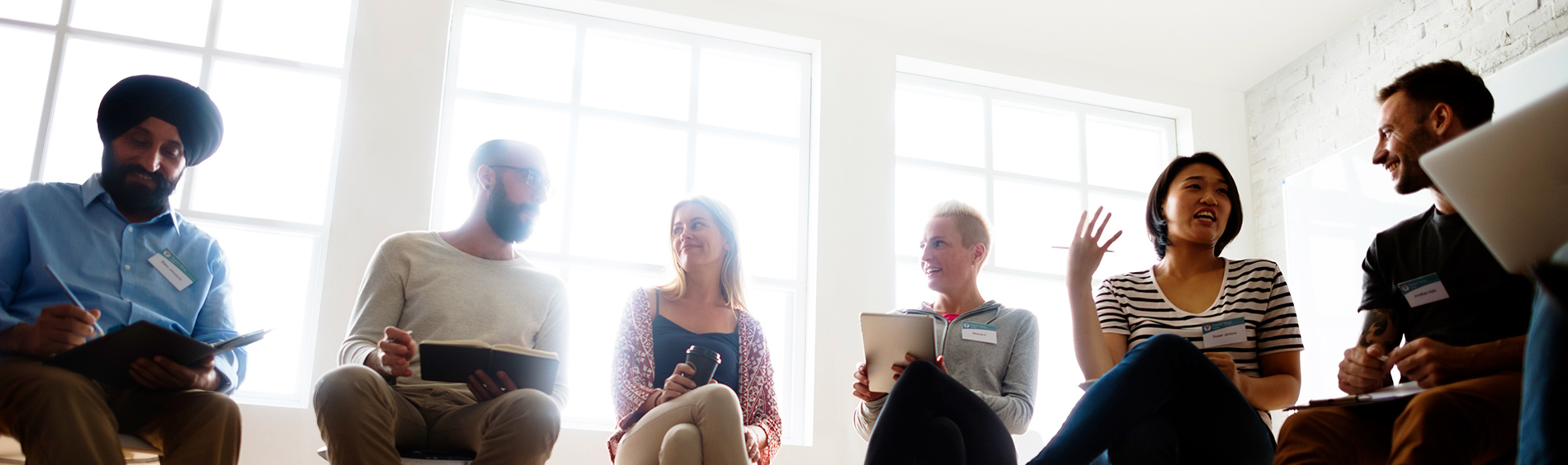 people sitting in semi-circle discussing