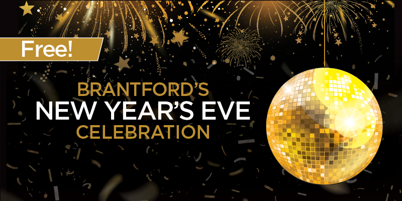 Gold disco ball and sparklers for Brantford's New Year's Eve with black background.