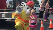 sparky mascot with child and firetruck