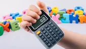 child holding calculator