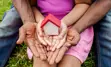 picture of hands holding a toy house