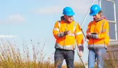 two field workers taking measurements