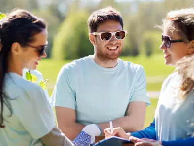Group of people wearing sunglasses and smiling