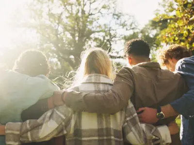 Group of friends embrace one another outside